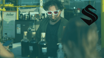 A bar scene symbolizing how a CRM like Selkire helps businesses remember personal details that build loyalty. The bartender recognizes the customer instantly, with a glowing clock behind them representing perfect timing and connection