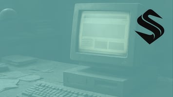 Dusty office with an old desktop computer displaying a dated static website interface