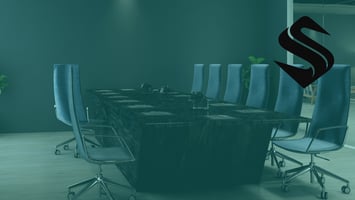 Empty boardroom with a long table and chairs, suggesting leadership decisions that shape marketing direction.