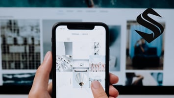 Smartphone displaying a social media feed, representing how Selkire views social media as a distribution channel within a broader marketing strategy.