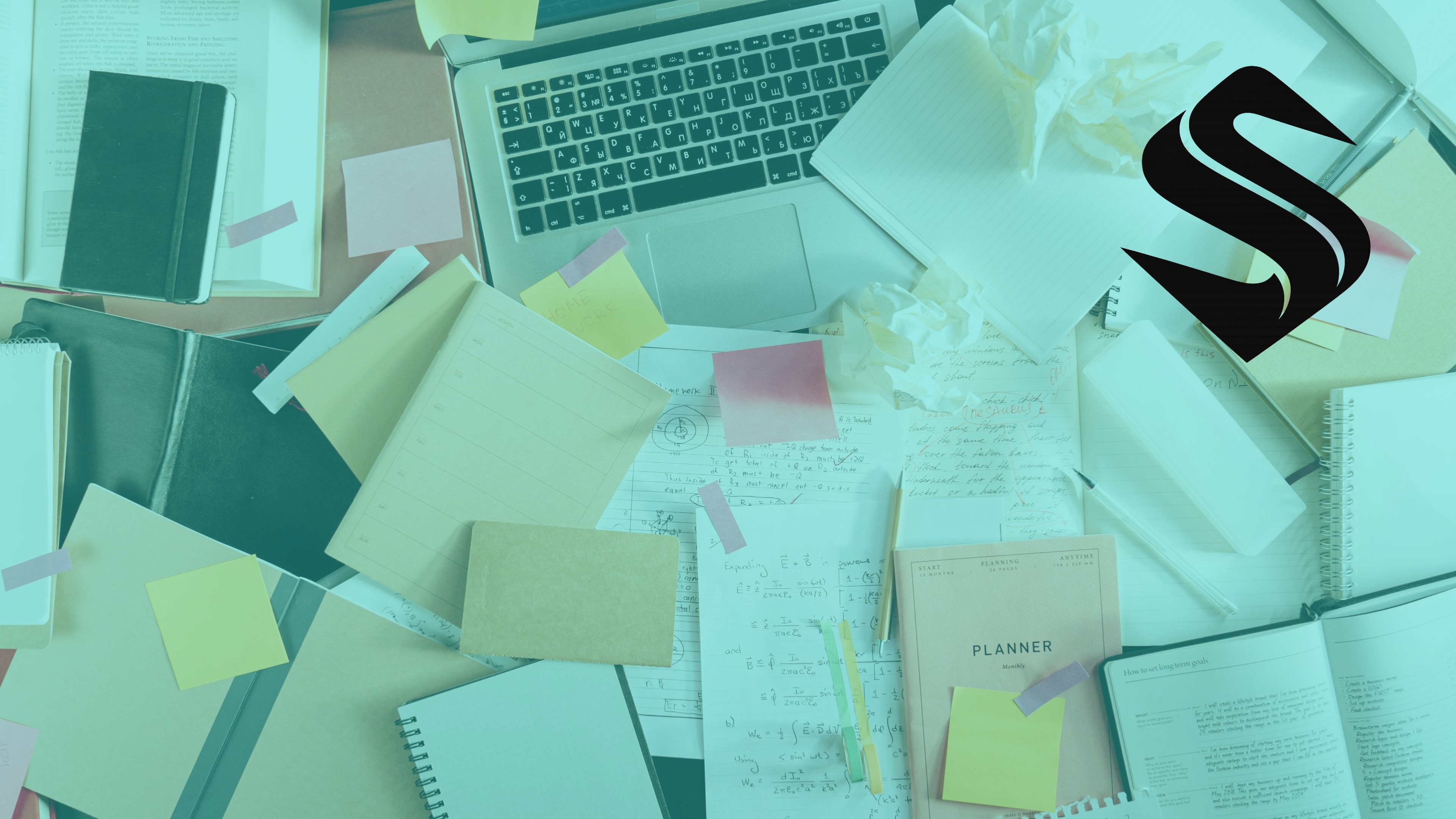 Cluttered desk with laptop, notes, and paperwork illustrating a CRM system overwhelmed by competing inputs and lack of ownership